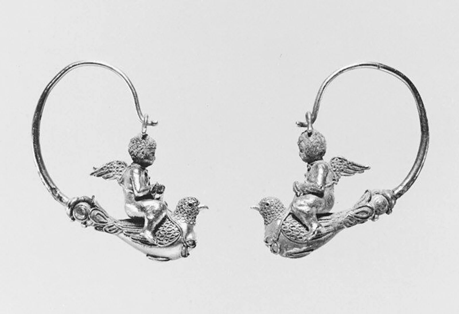 Pair of gold hoop earrings with Erotes riding doves